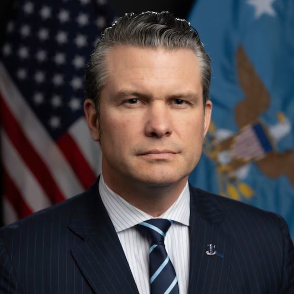 This is a formal, close-up portrait of Secretary of War Pete Hegseth. He is facing the camera directly from the chest up, maintaining a neutral and serious facial expression.